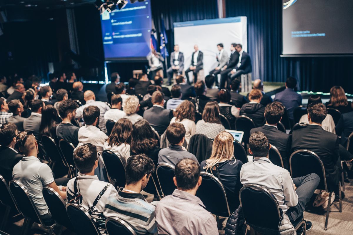 Delegates listen to speakers at a media relations conference