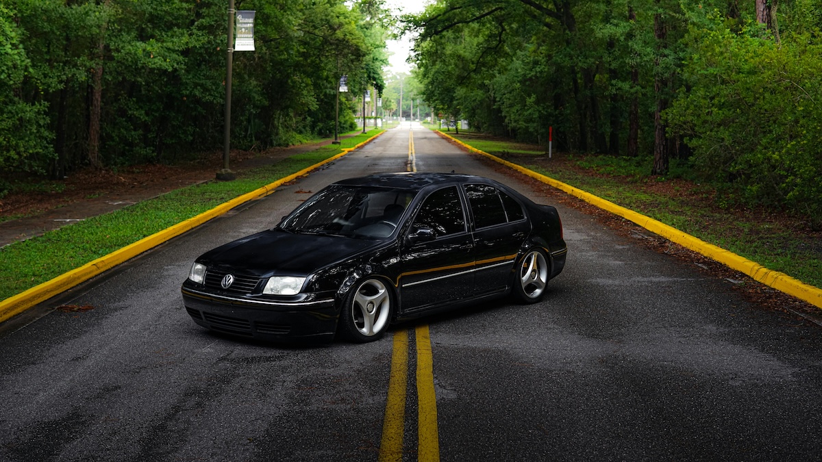 Black Volkswagen Jetta on a lonely road